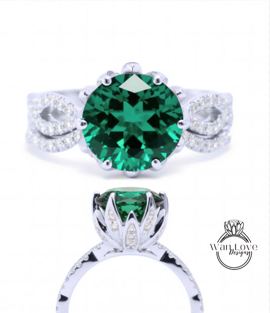 A close-up view of a silver ring with a large, green gemstone at the center. The ring has a delicate floral design around the gemstone and is set with smaller diamonds.