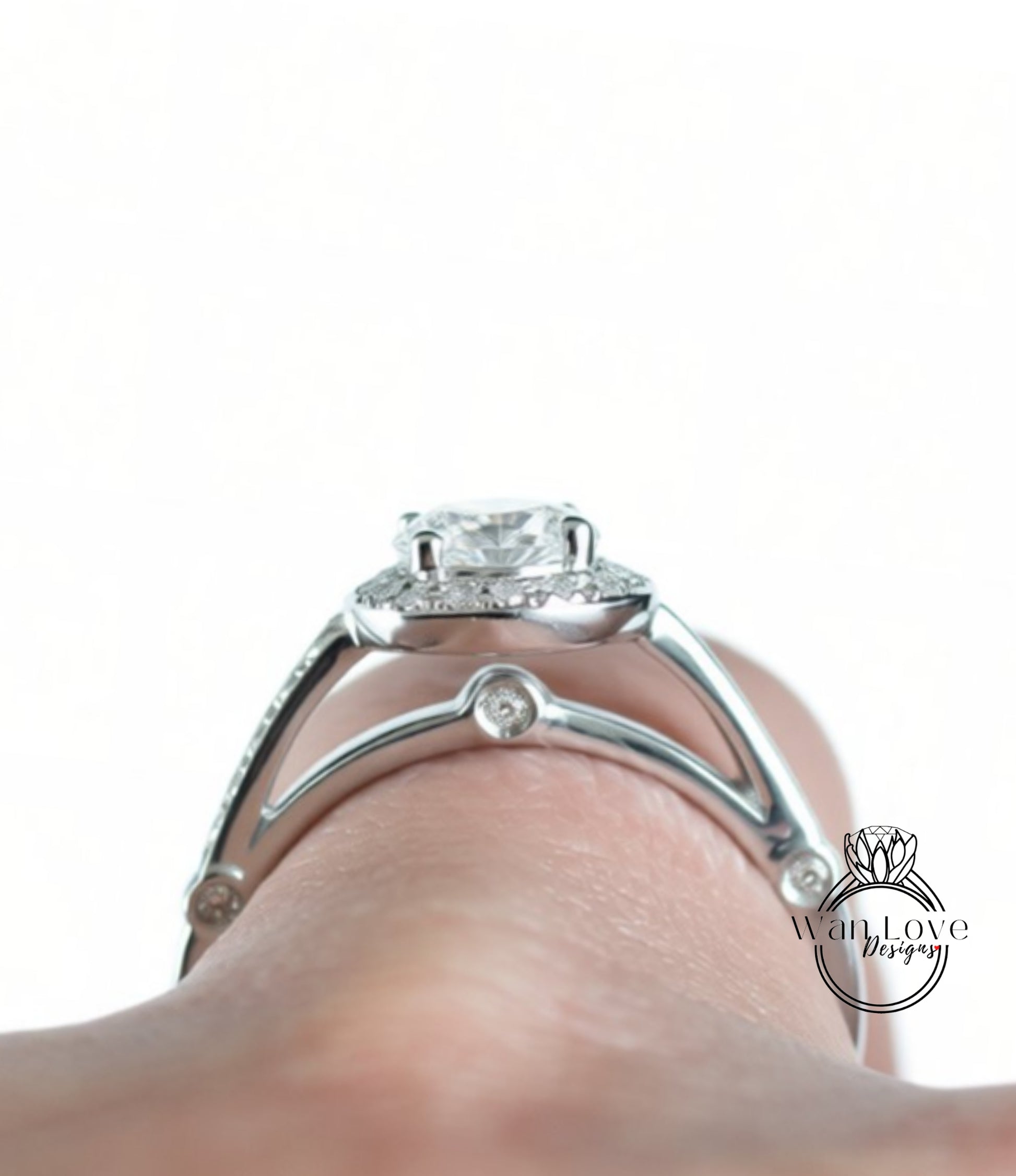A close-up view of a diamond engagement ring on a person's hand, showcasing the intricate design and sparkling gemstone.