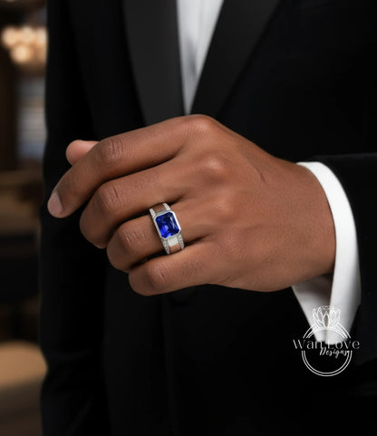 A close-up of a person's hand wearing a ring with a blue gemstone, likely a sapphire.