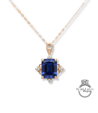 A necklace with a large blue gemstone pendant, surrounded by smaller diamonds, and a gold chain.