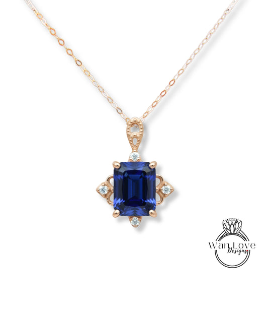A necklace with a large blue gemstone pendant, surrounded by smaller diamonds, and a gold chain.