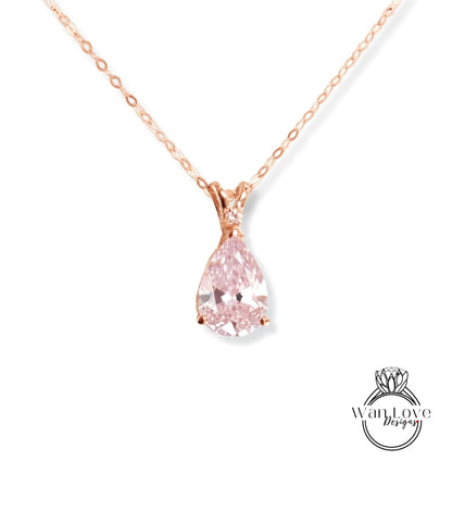 A delicate rose gold necklace with a single, large, clear pink diamond pendant.