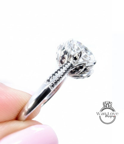 A close-up image of a person's hand holding a silver ring with a large, round diamond as the centerpiece.