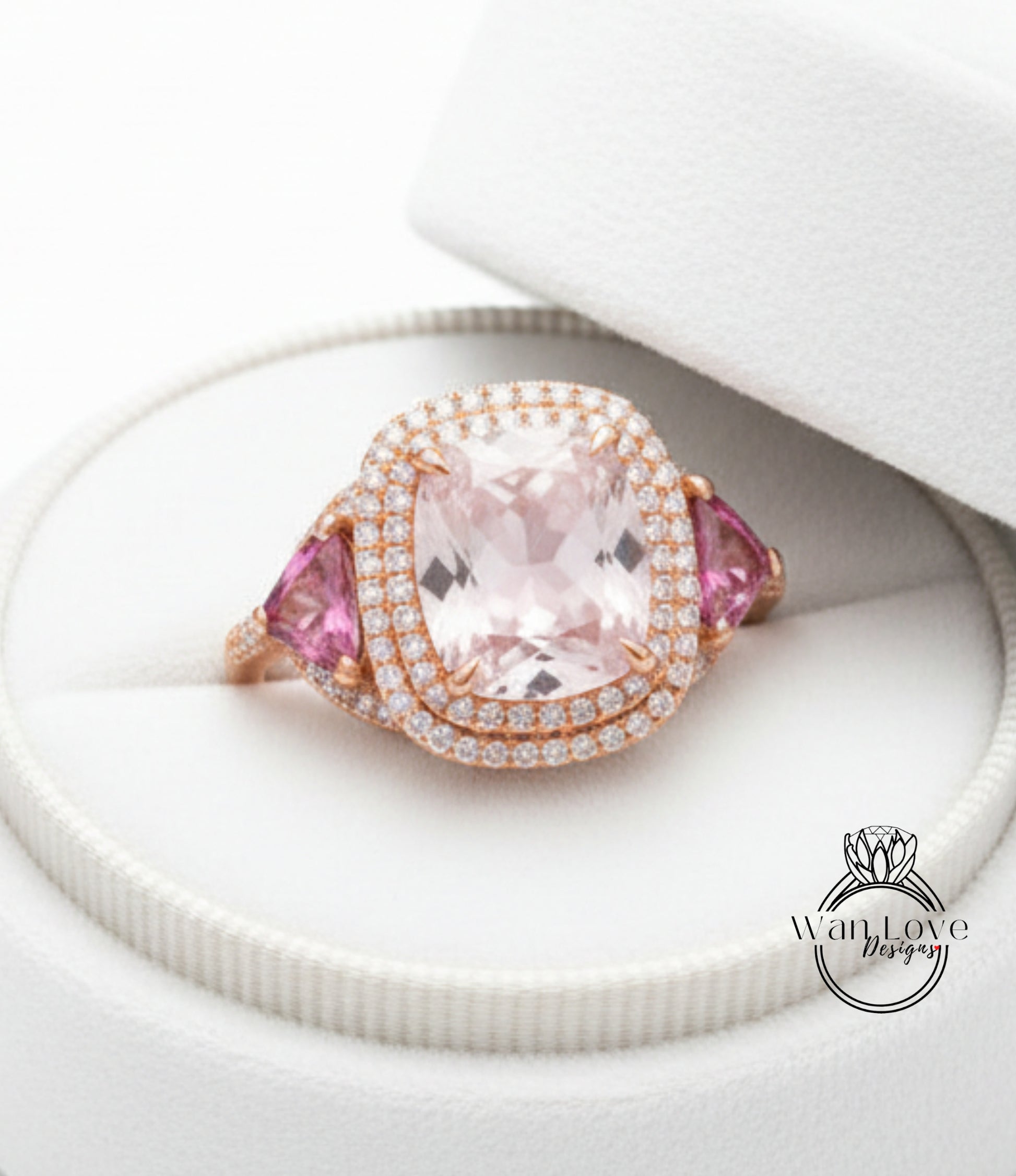 A large, pink gemstone ring with a halo of diamonds set in a white box.