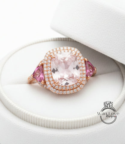 A large, pink gemstone ring with a halo of diamonds set in a white box.