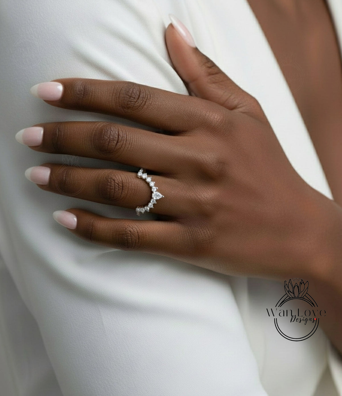 A close-up of a person's hand wearing a diamond ring on the ring finger.