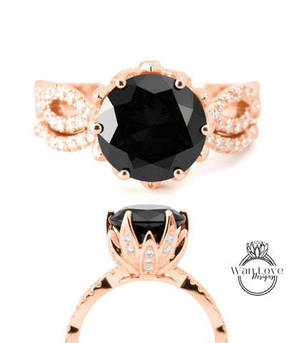 a rose gold ring with a large black gemstone, likely a diamond, as the centerpiece. The ring is adorned with a floral design and has a prominent rose gold band.