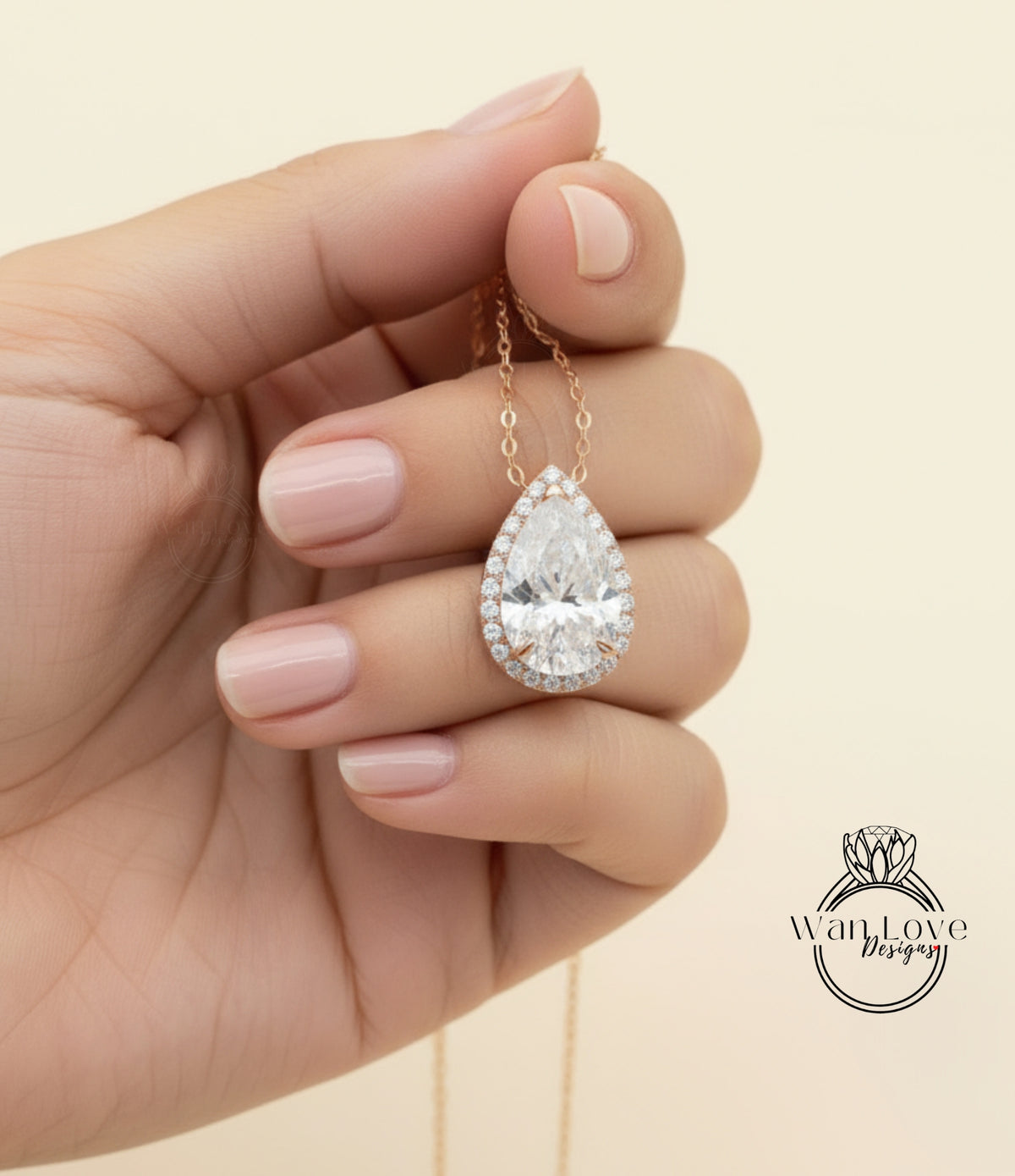 A hand holding a delicate necklace with a large, sparkling diamond pendant.