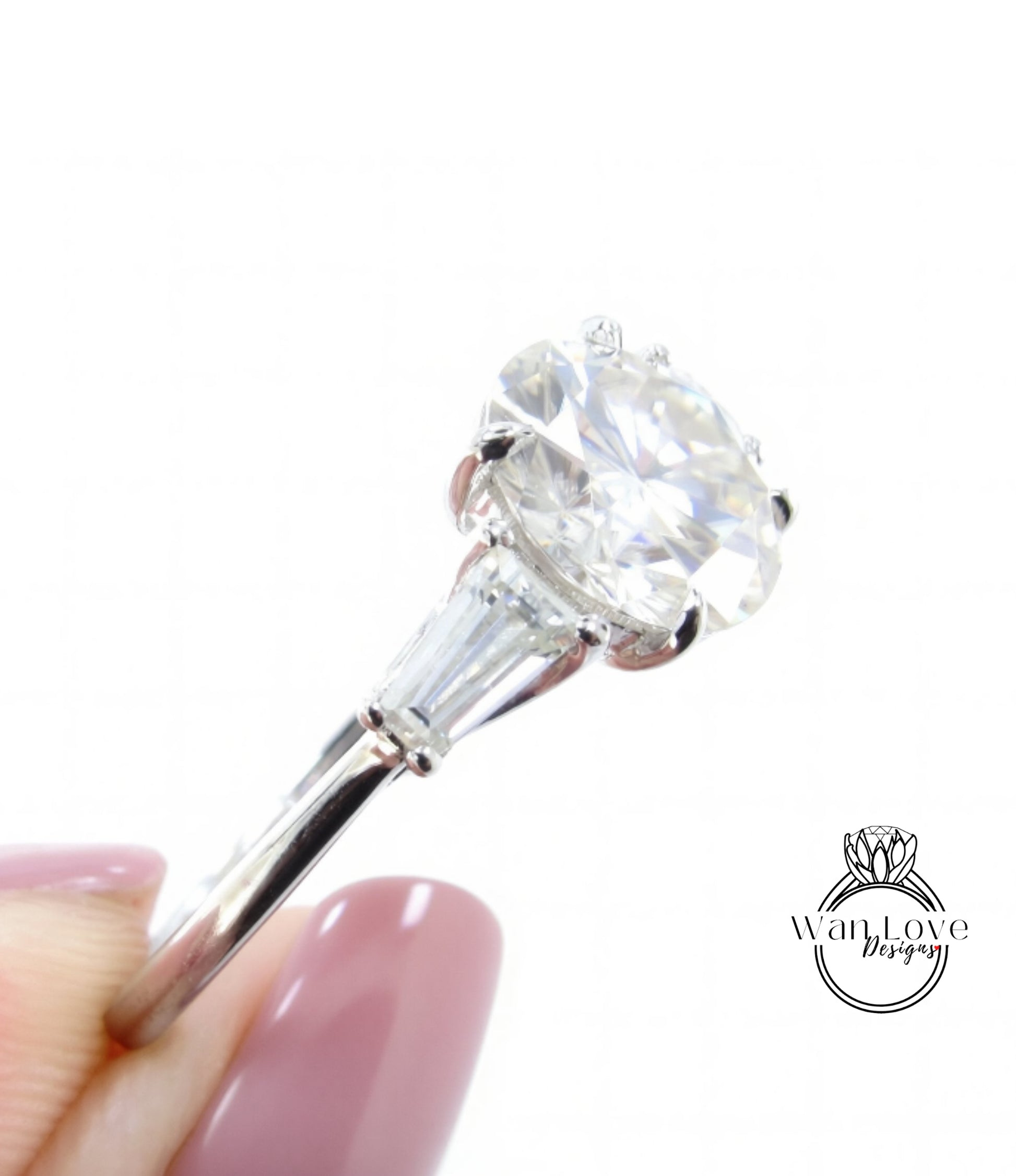 A close-up of a diamond engagement ring being held by a person's hand, showcasing the large, clear diamond set in a silver band.