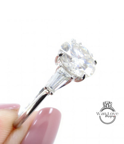 A close-up of a diamond engagement ring being held by a person's hand, showcasing the large, clear diamond set in a silver band.
