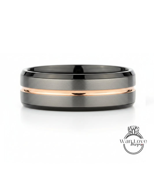 A silver and black ring with a thin gold stripe.