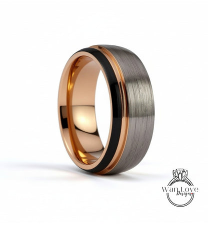 A close-up image of a silver and black ring with a thin gold band.