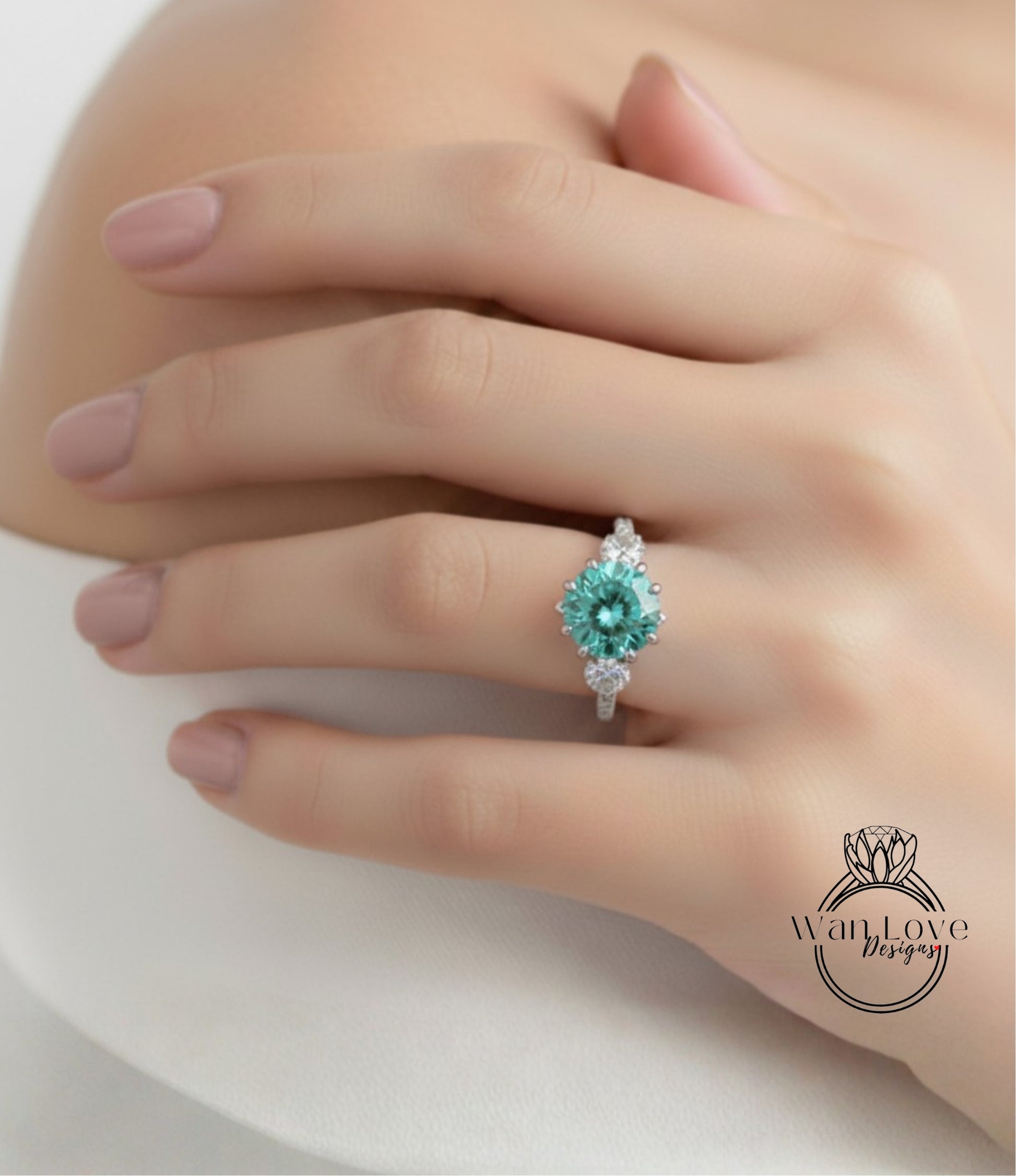 A close-up of a hand wearing a ring with a large, turquoise-colored gemstone.