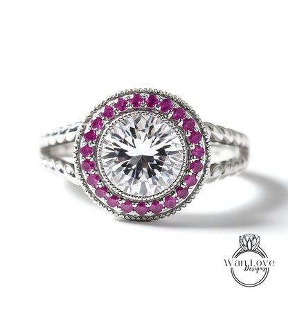 A close-up image of a diamond ring with a large central diamond surrounded by smaller diamonds and red gemstones.
