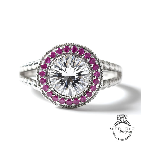 A close-up image of a diamond ring with a large central diamond surrounded by smaller diamonds and red gemstones.