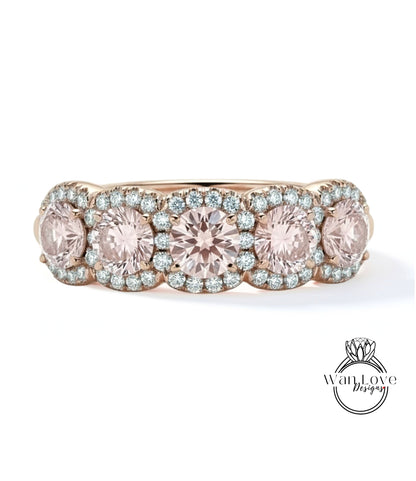 A gold ring with a row of pink diamonds set in the center, showcasing a beautiful and elegant design.