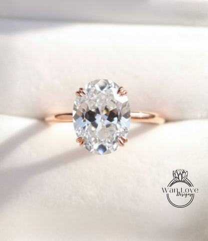 A close-up image of a diamond engagement ring with a large oval-shaped diamond set in a gold band.
