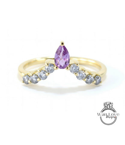 A gold ring with a large purple gemstone at the center, surrounded by smaller diamonds.