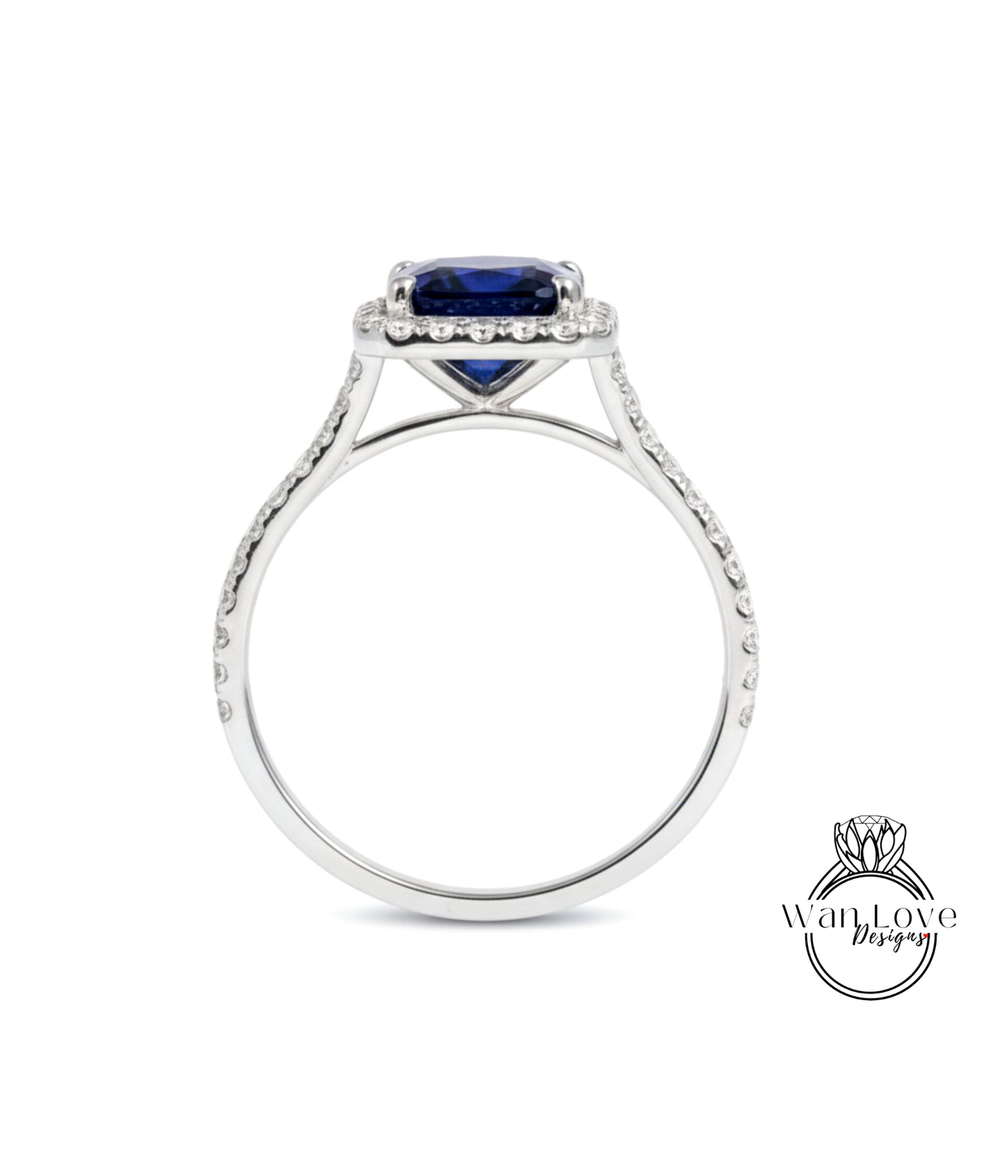 A silver ring with a large blue gemstone, likely a sapphire, set in a halo of smaller diamonds.