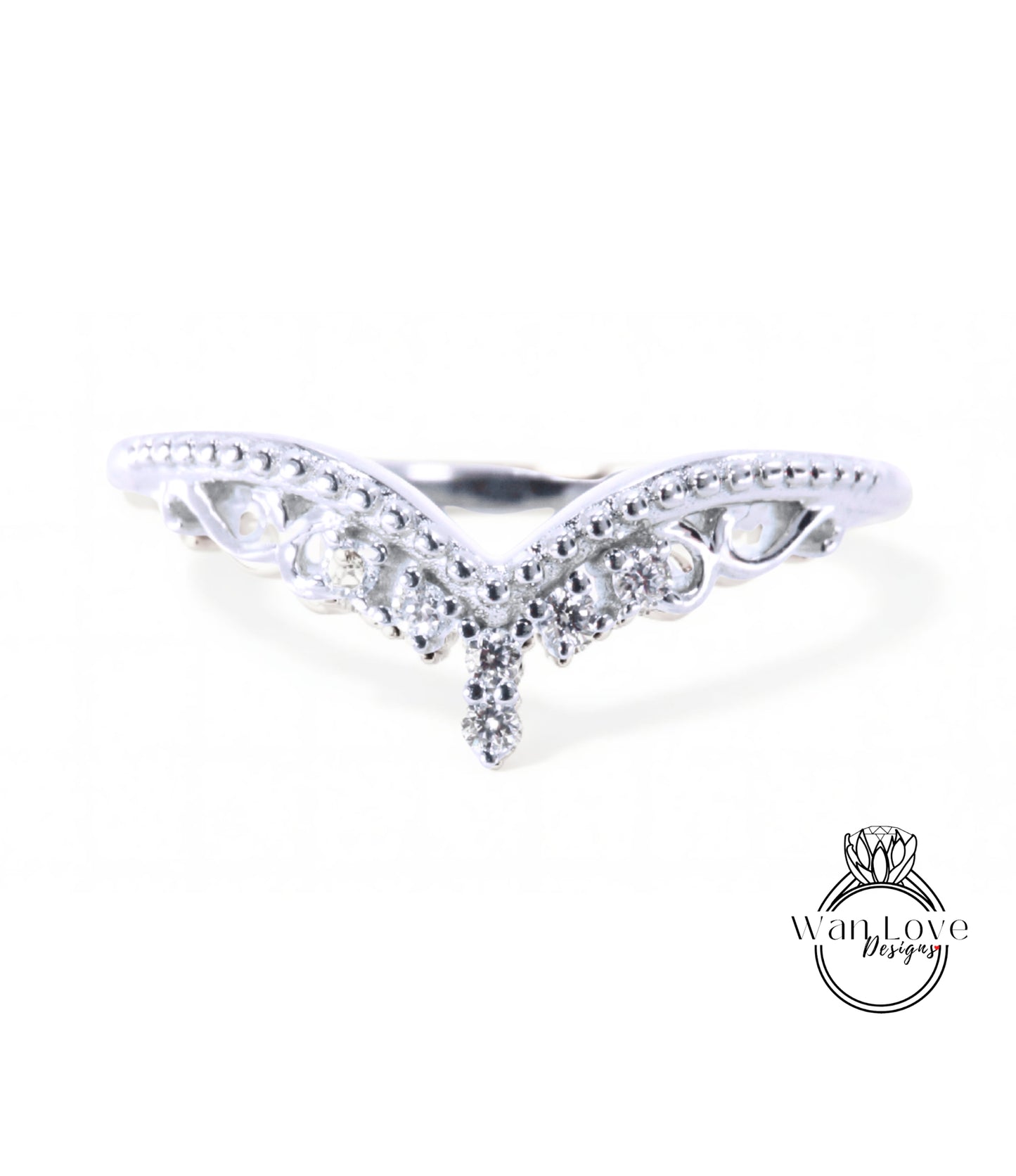 A silver ring with a decorative design featuring a central diamond and smaller diamonds surrounding it.