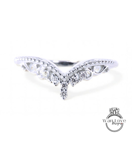 A silver ring with a decorative design featuring a central diamond and smaller diamonds surrounding it.