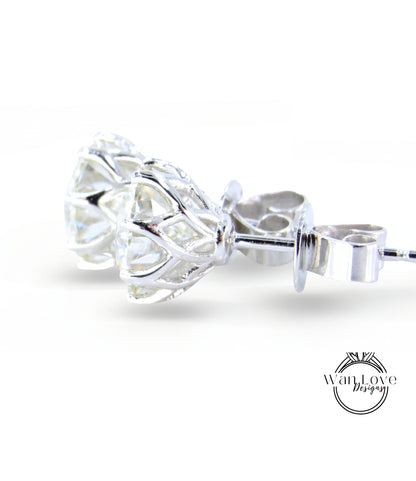 A close-up view of a pair of elegant silver earrings with a clear gemstone set in a delicate, intricate design.