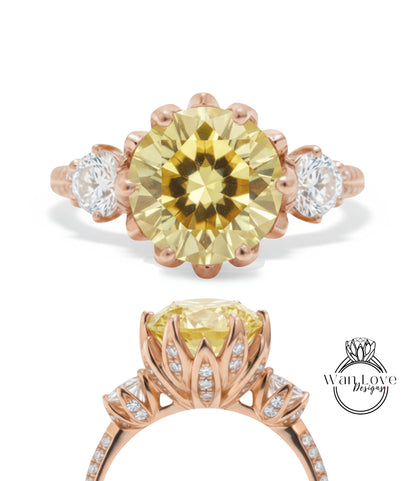 a beautiful yellow diamond ring with a large central diamond surrounded by smaller diamonds on either side. The ring is set in a rose gold band, and the overall design is elegant and eye-catching.