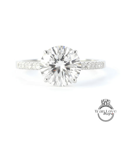 A close-up view of a diamond engagement ring with a large, brilliant-cut diamond set in a silver band.