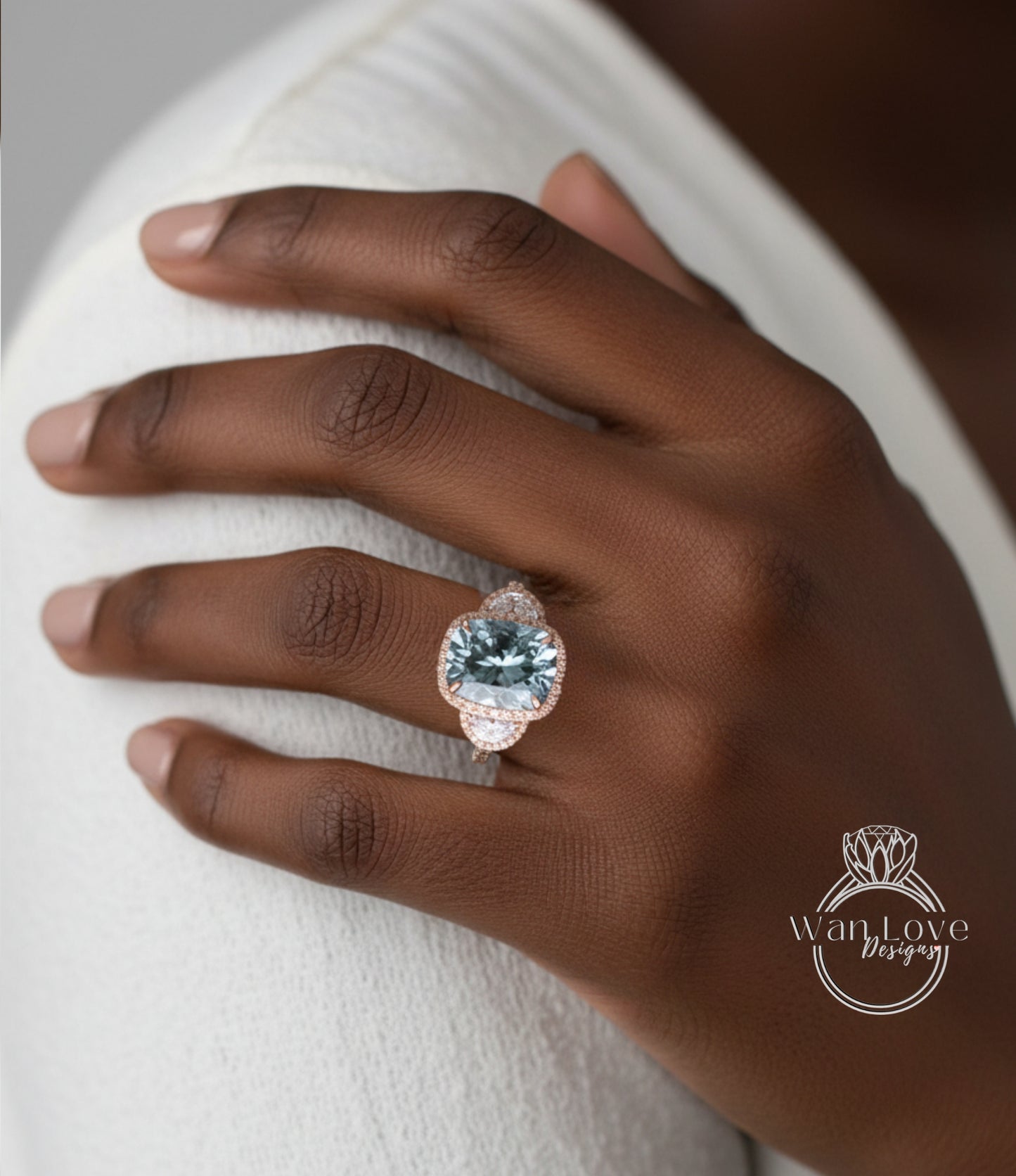 A close-up of a hand wearing a large, ornate ring with a large blue gemstone.