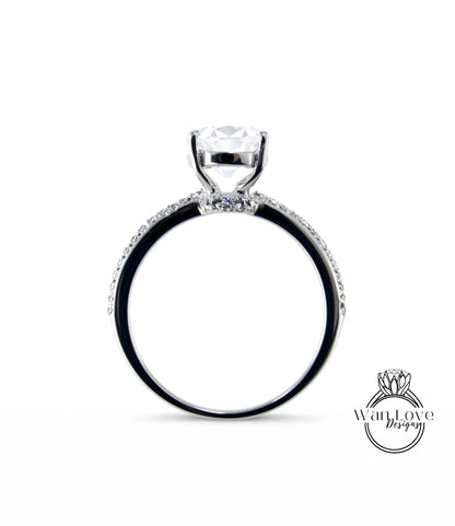 A silver engagement ring with a large central diamond and a halo of smaller diamonds around the band.