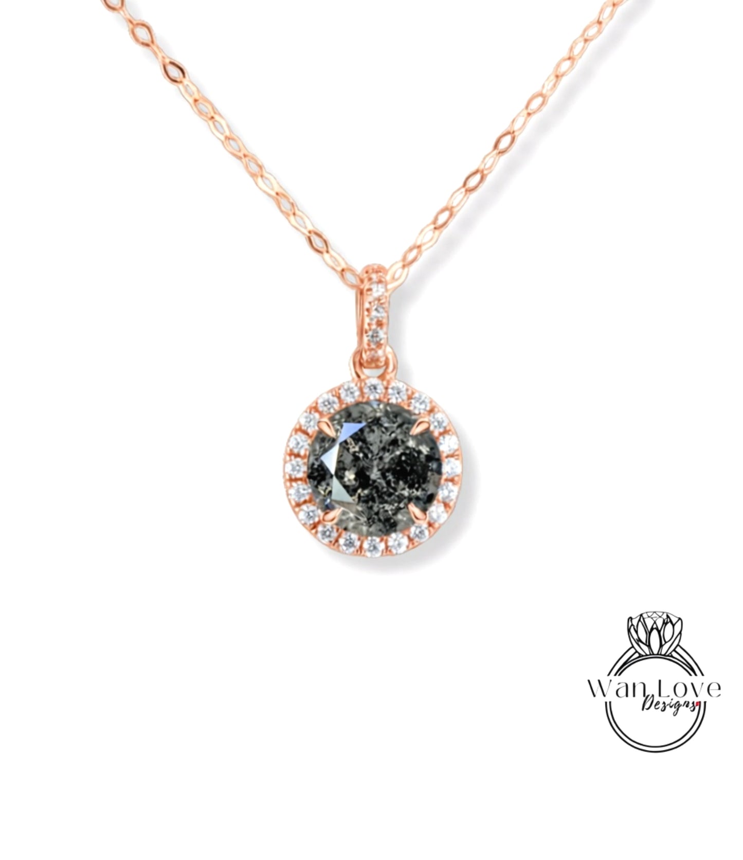 A necklace with a large, dark grey diamond pendant surrounded by smaller diamonds and set in a rose gold-colored frame.