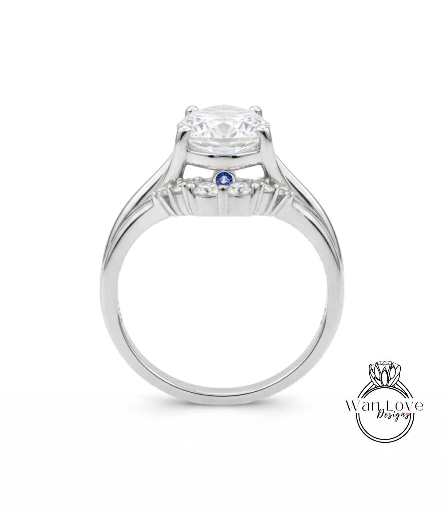 A silver engagement ring with a large central diamond and a smaller blue gemstone.
