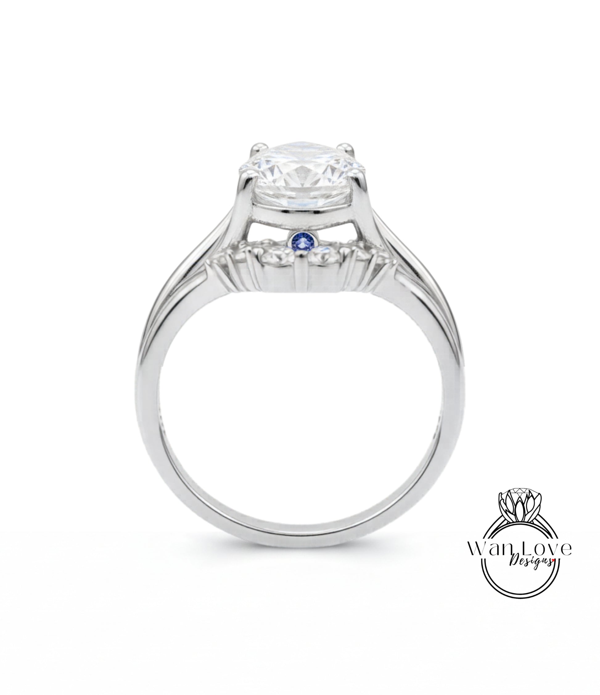 A silver engagement ring with a large central diamond and a smaller blue gemstone.