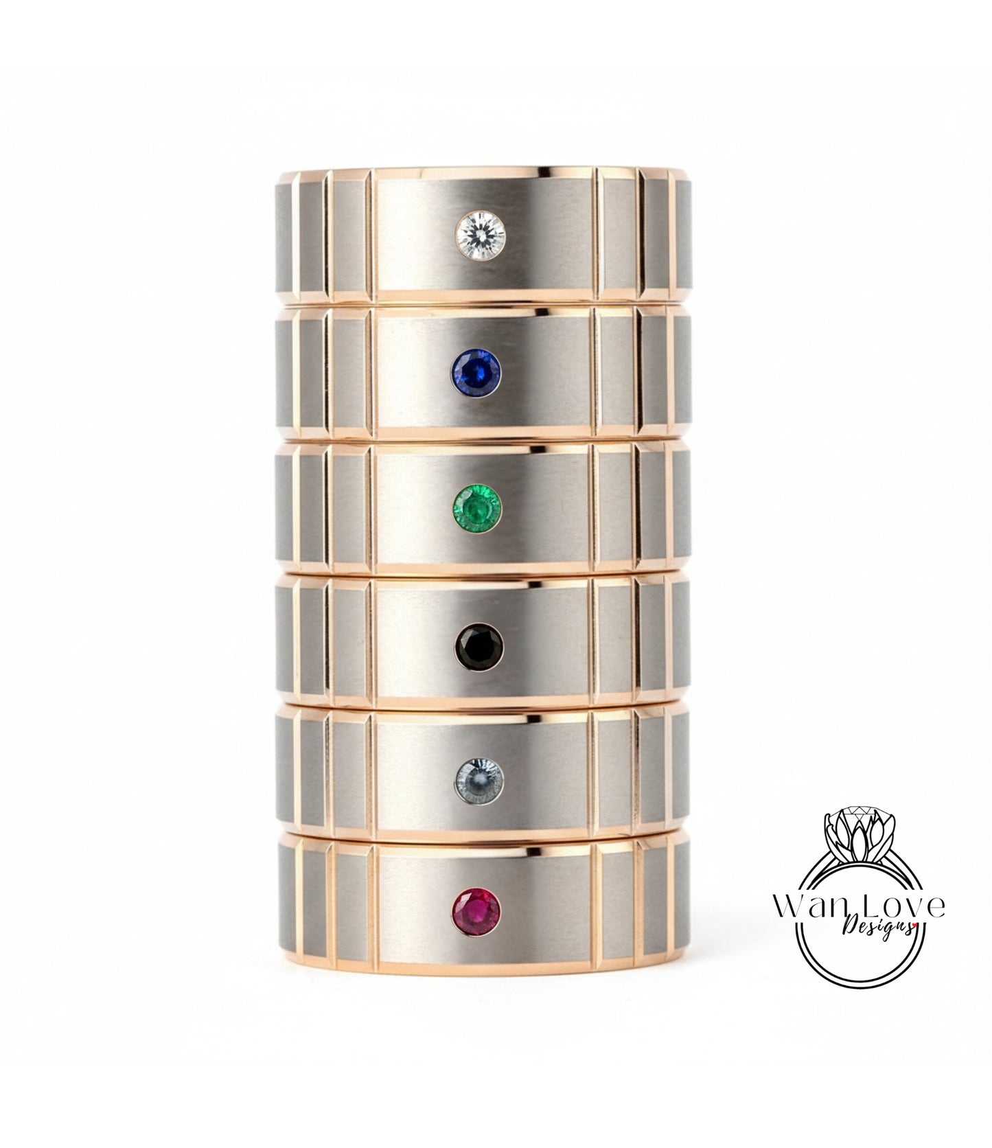 A stack of rings with gemstones on them, each ring has a different colored gemstone.