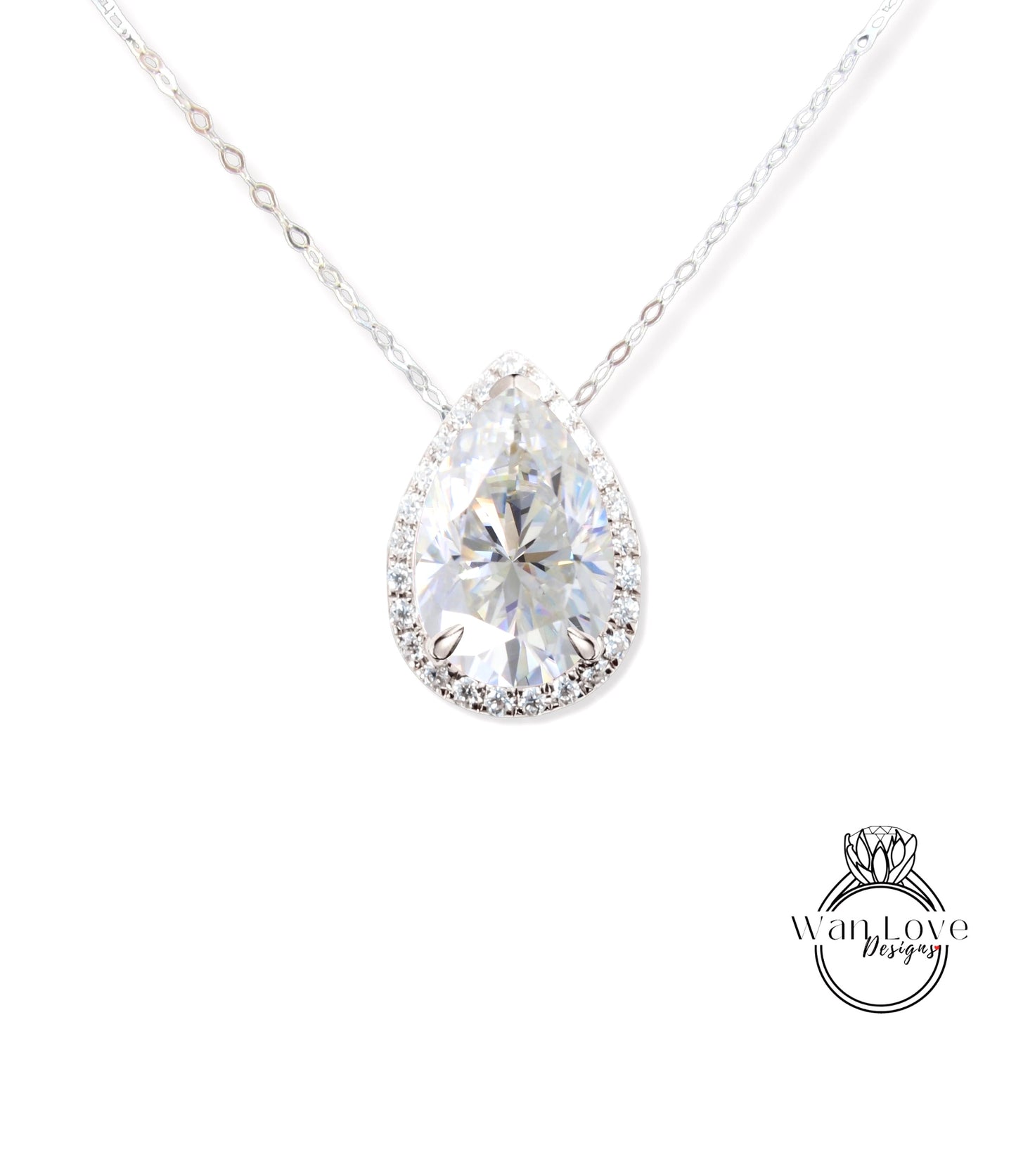 A close-up view of a diamond pendant necklace with a large, clear pear-shaped diamond set in a halo of smaller diamonds.