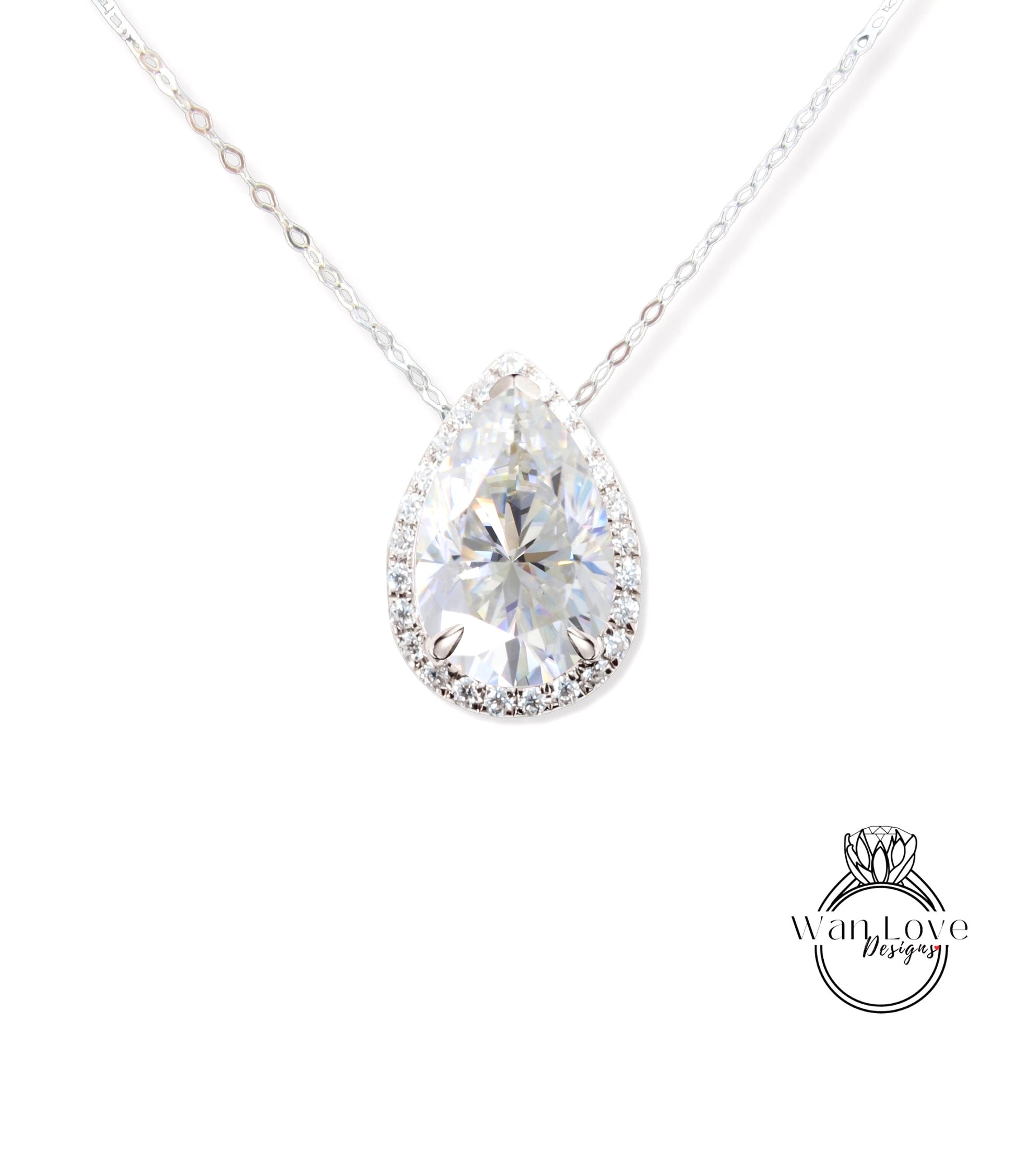 A close-up view of a diamond pendant necklace with a large, clear pear-shaped diamond set in a halo of smaller diamonds.