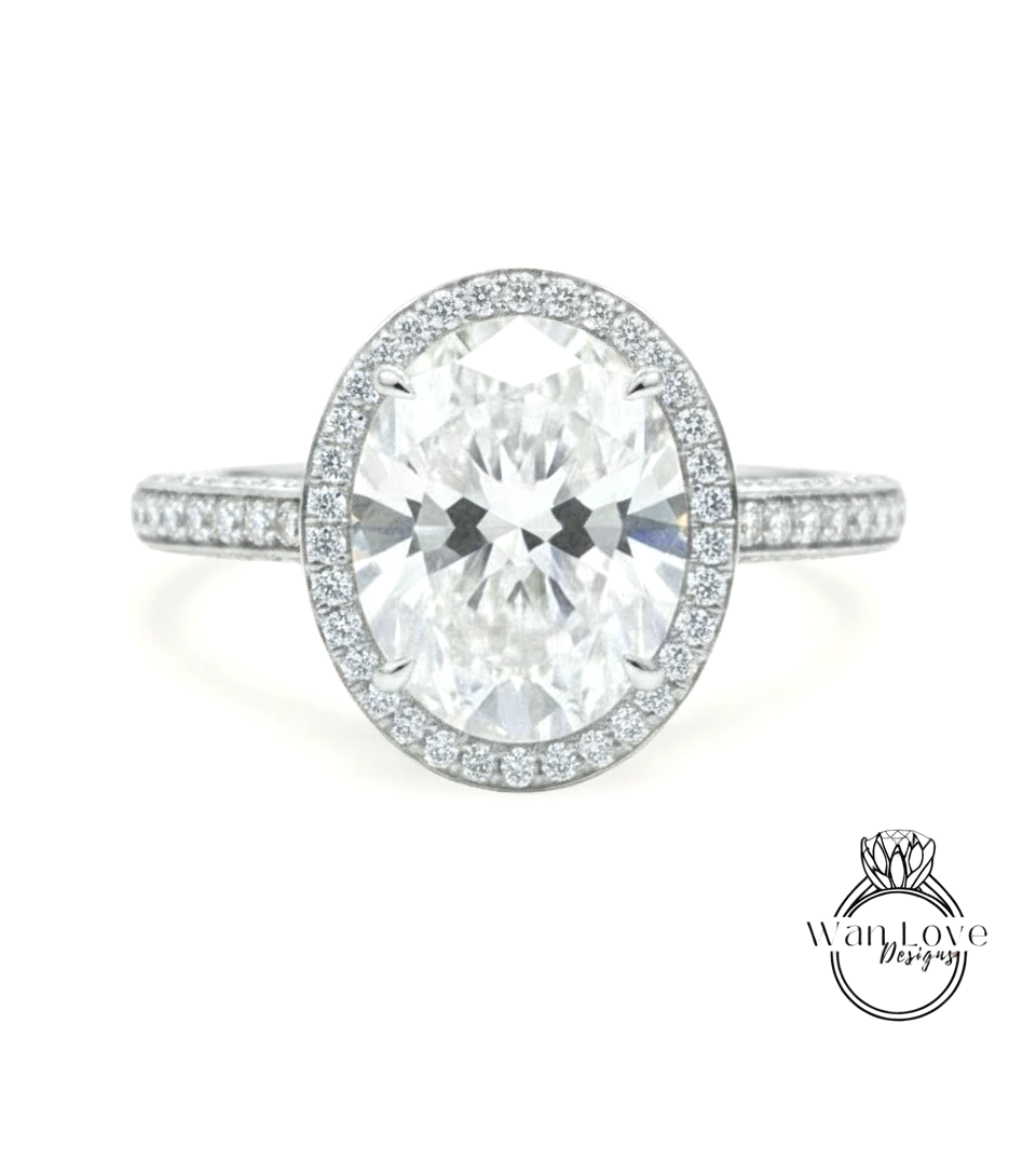 A large oval-shaped diamond ring with a halo of smaller diamonds around the center stone.