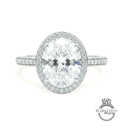 A large oval-shaped diamond ring with a halo of smaller diamonds around the center stone.