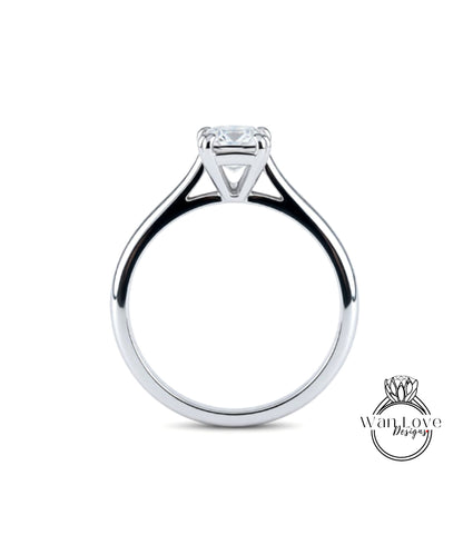 A silver engagement ring with a large diamond set in the center.