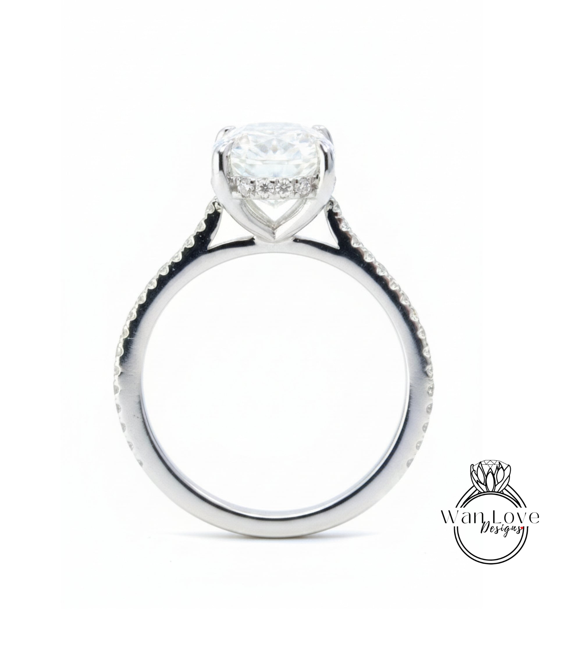 A silver engagement ring with a large central diamond and smaller diamonds around the band.