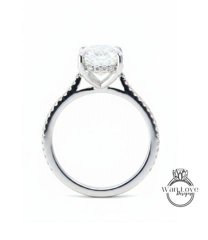 A silver engagement ring with a large central diamond and smaller diamonds around the band.