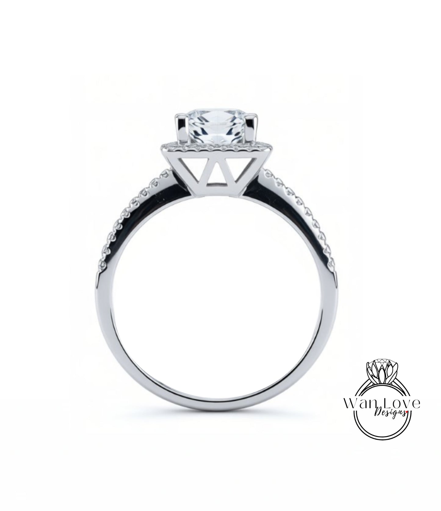 A silver engagement ring with a large central diamond and a halo of smaller diamonds around the top.