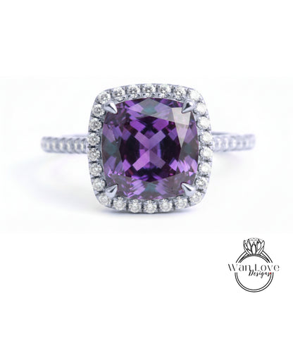 A stunning ring featuring a large, deep purple gemstone surrounded by a halo of sparkling diamonds.