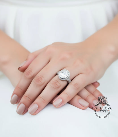 A close-up of a person's hands wearing a large, ornate ring on the ring finger.
