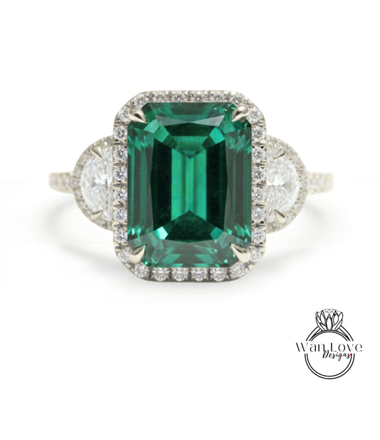 A large, green gemstone ring with a halo of smaller diamonds around the center stone.