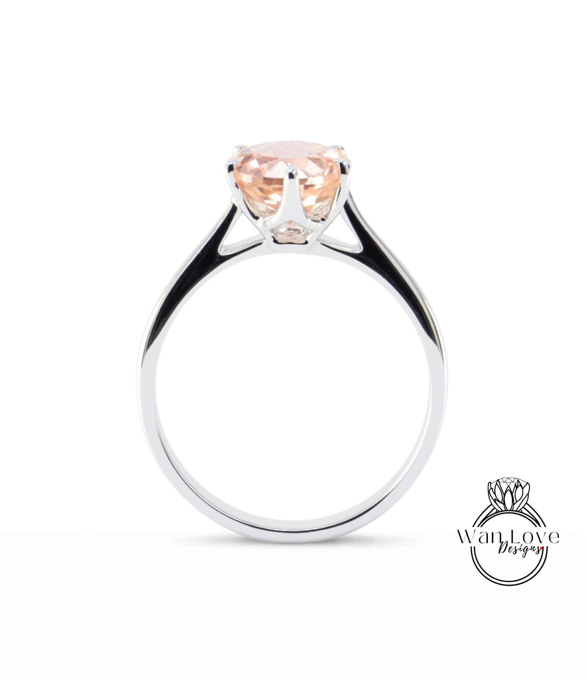 A silver ring with a large, light pink gemstone set in the center.