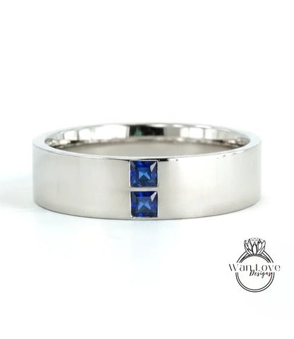 A silver-colored ring with two blue gemstones set in the center.