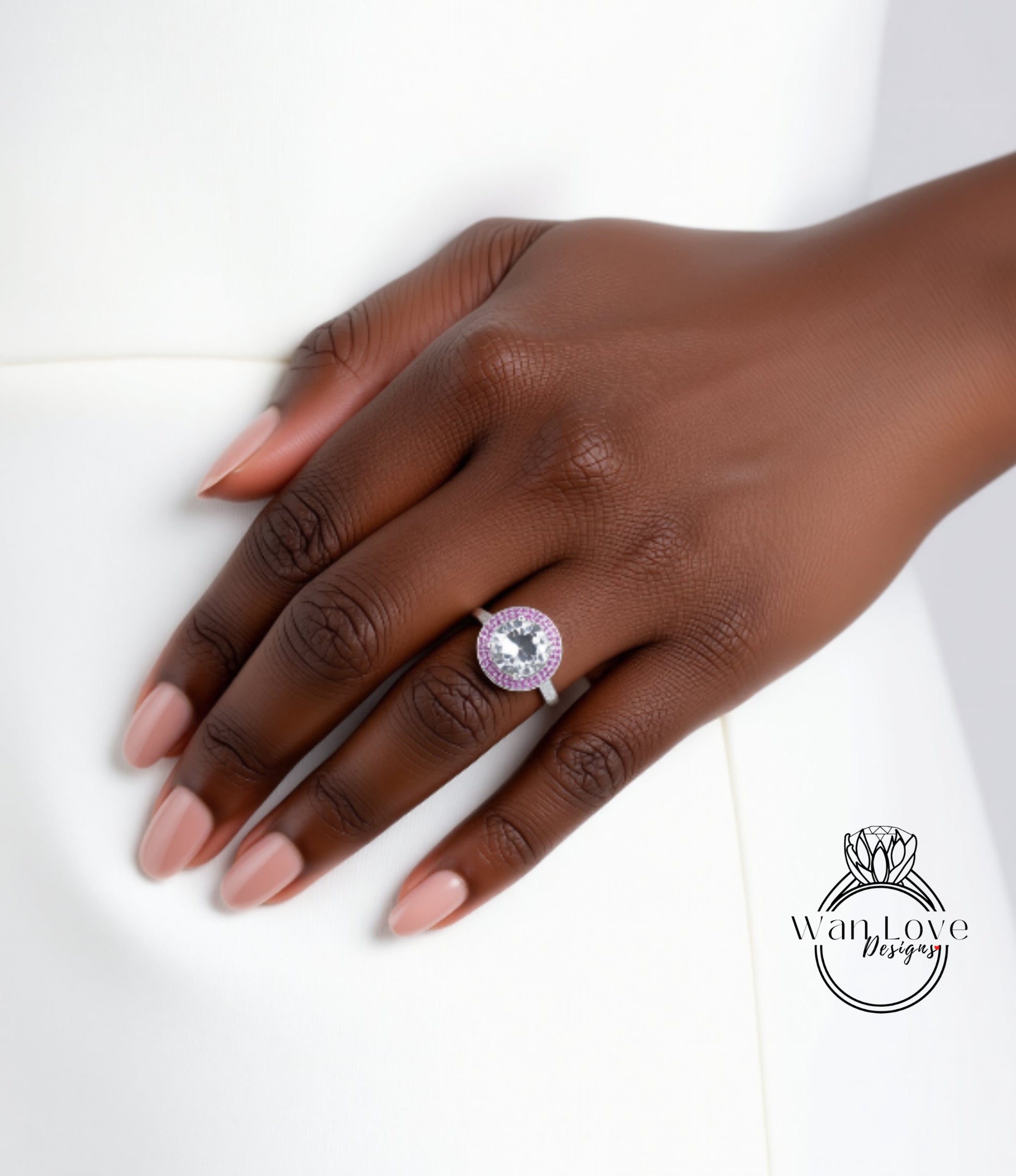 A close-up of a hand wearing a ring with a large, clear gemstone.