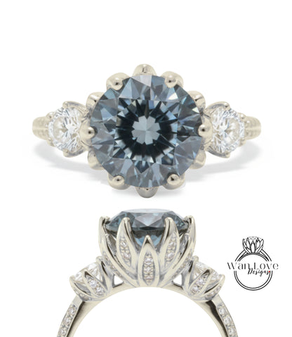 A silver engagement ring with a large blue gemstone, surrounded by smaller diamonds.