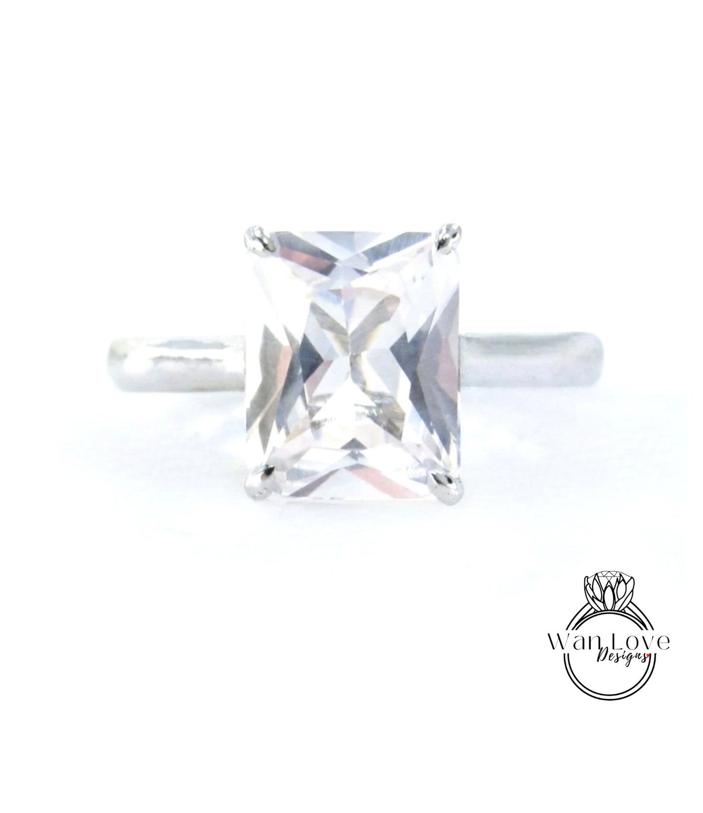 A close-up image of a diamond ring with a large, clear gemstone set in a silver band.